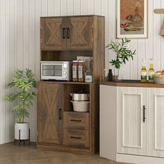 a kitchen area with a microwave, cabinet and potted plant