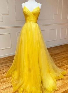 Seek the spotlight in this stunning yellow prom dress, designed to make a memorable impression. The dress features a sophisticated sweetheart neckline with delicate spaghetti straps that add a touch of elegance. The bodice is expertly ruched to enhance your natural shape, cinching at the waist to create a flattering silhouette. The skirt flows into a full-length A-line design, made from layers of soft tulle that create a graceful and fluid movement. The vibrant yellow color is both striking and cheerful, ensuring you stand out in any crowd. The back of the dress features a seamless zipper closure, providing both style and comfort. Ideal for prom, weddings, or any special occasion, this dress will make you feel confident, beautiful, and ready to shine. Prom Dress Yellow, Yellow Formal Dress, Yellow Evening Dresses, Tulle Long Prom Dress, Princess Clothes, Prom Dresses 2022, Tulle Balls, Prom Dresses 2023, Prom Dresses 2024