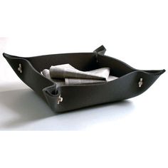 a black leather tray with napkins in it