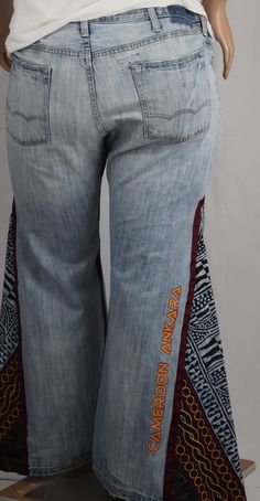 Handcrafted One-Of-A-Kind LRD unisex pieces are about FIT. Offering accommodating sizes that may fit male and female body frames; not about androgynous fashion that is trying to find a middle ground between both genders. These one-of-a-kind jeans are truly unique: The wide leg bell bottoms embrace a retro-inspired look that's sure to turn heads. Let the cool breeze flow with the convenience of two fully functioning side seam metal zippers. The 100% cotton African wax print fabric leg insets and Bohemian Wide Leg Cotton Jeans, Bohemian Style Denim Blue Cotton Pants, Bohemian Denim Blue Cotton Pants, Embroidered Cotton Jeans In Denim Blue, Embroidered Denim Blue Cotton Jeans, Festival Wide Leg Cotton Jeans, Embroidered Denim Blue Cotton Flare Jeans, Casual Embroidered Cotton Flare Jeans, Embroidered Dark Wash Cotton Bottoms