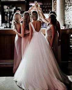 the bride and her bridesmaids are getting ready to go into their wedding ceremony