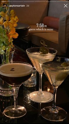 three martini glasses sitting on top of a table