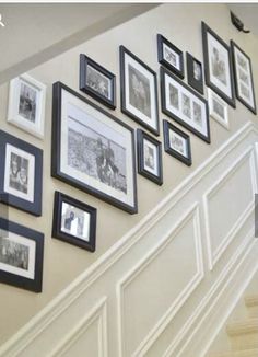 a staircase with many framed pictures on the wall