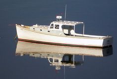 a white boat floating on top of a body of water