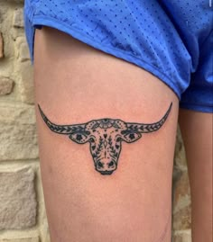 a bull's head is shown on the side of a woman's thigh