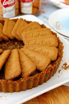 a chocolate tart with cookies cut into it