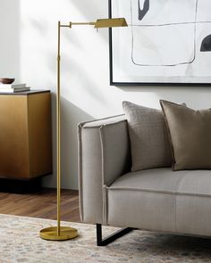 a living room scene with focus on the floor lamp and beige couch in the foreground