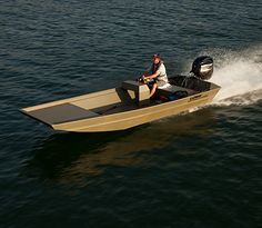 a man riding on the back of a small boat in the middle of the water