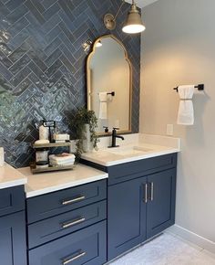 a bathroom with two sinks and blue cabinets