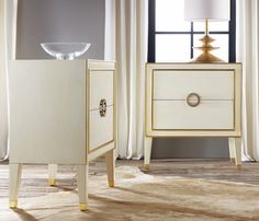 two white and gold nightstands sitting next to each other in front of a window