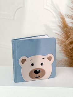 a blue book with a white bear face on it sitting on top of a shelf