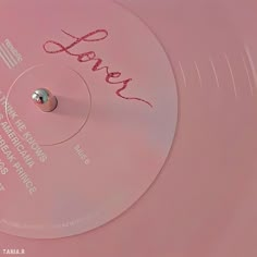 a close up of a pink disc with writing on the side and an inscription that reads love