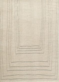 an area rug with squares and lines on the side, in neutral colors is shown