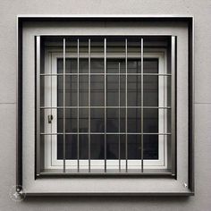 a window with bars on the side of it