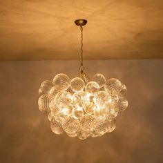 a chandelier hanging from the ceiling in a room with no one around it