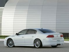 a white car parked in front of a building