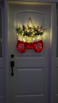 a door decorated with christmas stockings and lights