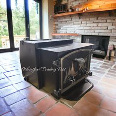 a stove top oven sitting inside of a living room next to a fire place in a fireplace