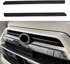 the front bumper cover and grille guard on a white car with black trimmings