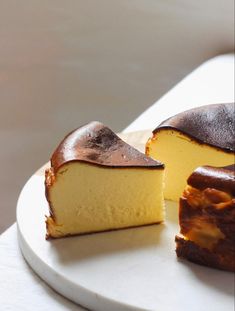 two pieces of cake sitting on top of a white plate