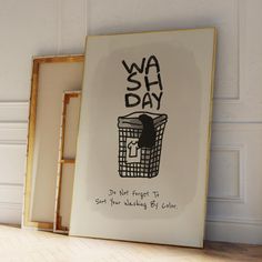 a framed poster with the words wash day written on it next to an empty box