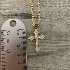 Gold plated necklace. Pendant measurement: 3 cm long x 2.2 cm wide Chain measurement : 3mm thickness Figaro chain included Gold Tarnish-resistant Cross Pendant Necklace, Gold Crucifix Necklace With Box Chain, Tarnish-resistant Yellow Gold Cross Pendant Necklace, Gold-plated Tarnish-resistant Crucifix Necklace, Keychain Necklace, Yellow Gold Crucifix Cross Necklace, Gold Plated, Figaro Chains, Anklet Bracelet, Gold Plated Bracelets