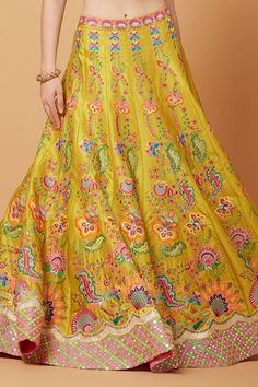 Yellow lehenga featuring fresh gardenia embroidery with multi thread, tonal sequins, crystals, cut dana, and beads highlights. Paired with a plunging scallop V neck padded blouse and a neon pink mirror border embroidered net dupatta., Fit: Relaxed Summer Lehenga With Cutdana In Saree Style, Summer Reception Lehenga In Saree Style, Summer Wedding Saree Set, Summer Wedding Lehenga With Zari Work, Summer Wedding Choli With Zari Work, Summer Wedding Sharara With Resham Embroidery, Traditional Summer Wedding Lehenga, Summer Wedding Set With Zari Work, Summer Silk Lehenga With Resham Embroidery