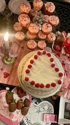 a table topped with lots of cupcakes and cakes