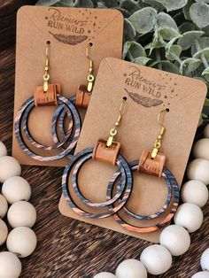 Wood and Faux Leather Earrings: Make a statement with these beautiful boho earrings for women. These wooden dangle earrings are a perfect gift for your best friend or a wonderful birthday gift for your girlfriend. The colorful wooden circles come in an array of fun colors and paired with a light brown faux leather and gold colored stainless steel hardware.  Size:  *Pendant Size: 1.5 inches *Dangle Size: 2.5 Inches Material:  *Hardware: Gold Colored Stainless steel that is great for sensitive ear Cheap Bohemian Leather Earrings, Handmade Brown Jewelry For Gift Making, Unique Brown Hoop Earrings For Gift, Handmade Brown Hoop Earrings As Gift, Nickel-free Brown Hoop Earrings As Gift, Brown Hoop Earrings With Ear Wire For Gift, Wood And Leather Earrings, Boho Earrings Hippie Bohemian, Boho Leather Jewelry