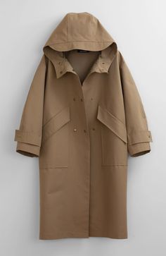 Fabric: 73% Cotton, 27% NylonColor: Light BrownCare: Hand wash / Dry clean Waterproof oversized hooded trench coat with two front pockets and centre front bottom closure. The length is 46-47 inches (118-120 cm). Unlined. Consider wearing at a temperature 68-50°F (20-10°C) Made in USA. Pijamas Women, Double Breasted Vest, Khaki Trench, Khaki Trench Coat, Hooded Trench Coat, Waterproof Coat, Hooded Vest, Hooded Raincoat, Cotton Vest