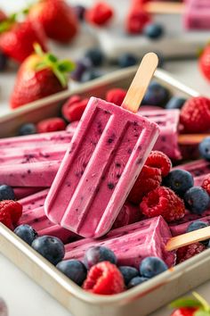 popsicles with berries, raspberries and blueberries on them