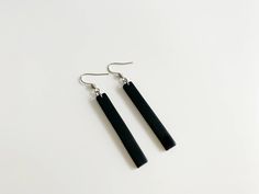 These elegant minimalist drop earrings are great for special occasions or everyday wear. Match these long black earrings with an elegant or casual outfit. Minimalist and sophisticated. These modern black bar earrings are handmade of polymer clay and mounted on stainless steel posts. Suitable for those with sensitive ears. YOU WILL GET → one pair of black long bar earrings → measurements: length - 5 cm (1.96 inches); width - 0,7 cm (0.23 inch); drop length - 7 cm (2.75 inch) → MATERIALS: Polymer