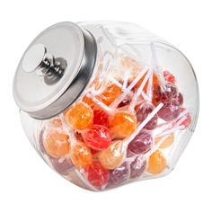 a glass jar filled with candies and lollipops on a white background