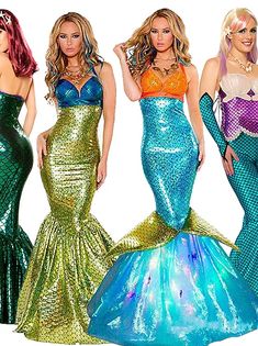 three women in mermaid costumes standing next to each other with their hands on their hipss