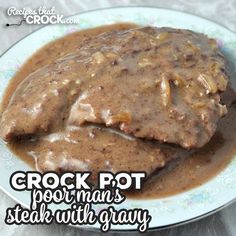 a white plate topped with meat covered in gravy