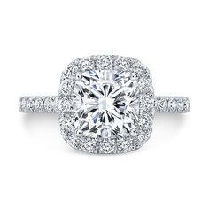 a cushion cut diamond surrounded by pave set halos in 18k white gold