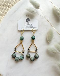 These are large, beaded, teardrop shaped statement earrings featuring 10mm African Turquoise beads, 4mm Dalmatian Jasper beads, rectangular Dalmatian Jasper beads, and shiny gold plated accents.These unique boho earrings hang approximately 3.0" inches from the lobe. The closure is a real gold plated leverback hoop and should be suitable for sensitive ears.These earrings are semi-lightweight and should be suitable for several hours of wear. Bohemian Drop Earrings With Gemstone Beads, Gold Teardrop Earrings With Gemstone Beads, Bohemian Teardrop Gemstone Bead Earrings, Gold Bohemian Teardrop Earrings With Round Beads, Dalmatian Jasper, African Turquoise, Bohemian Earrings, Jasper Beads, Large Earrings