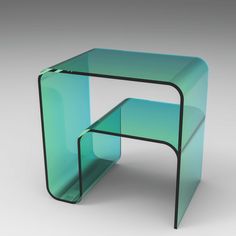 a glass table with a black metal frame on the top and bottom, against a gray background