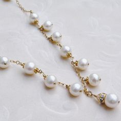 This romantic white pearl necklace is handmade with perfectly polished natural freshwater pearls and just enough sparkly Swarovski crystal accents. Expertly hand wire wrapped with 14k gold filled wire, chain and clasp. A gorgeous statement necklace for a blushing bride on her wedding day. A thoughtful gift for a woman born in June since her birthstone is the precious pearl. Necklace Details: - Necklace Length is 18 inches (43.18 cm) plus a 1 inch extender for the perfect fit - The central pendan Celebration Pearl Drop Necklace In Pearl White, Celebration Pearl Necklace, Celebration Pearl Necklace With Pearl Pendant, Pearl White Pearl Jewelry For Celebration, Pearl Necklace With Pearl Charm For Celebration, Celebration Pearl Necklace With Pearl Charm, Yellow Gold Pearl-embellished Necklaces For Wedding, Yellow Gold Pearl Necklaces For Wedding, Pearl Drop Bridal Necklace For Mother Of The Bride