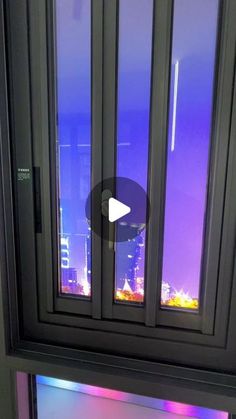 a window with an image of the city lights in it's glass panes