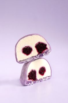 two pieces of cake sitting on top of each other in front of a purple background