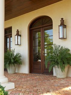 two large planters on the outside of a house