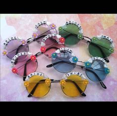 six pairs of sunglasses with flower decorations on the sides and one pair is blue, yellow, pink, green