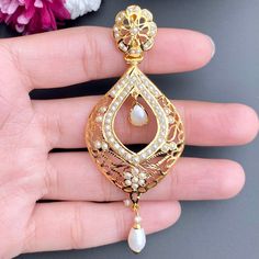 Intricately crafted, lightweight jadau earrings with fine jali work cut out, made in silver and set with real freshwater pearls. Weight 16 GMs Height - 8.25 cm Width - 3.5 cm Festive 22k Gold Pearl Drop Earrings, Diwali Gold Plated Pearl Drop Earrings, 22k Gold Intricate Design Drop Earrings, Gold-plated Pearl Drop Jhumkas, Gold Meenakari Drop Pearl Earrings, Jali Work, Jadau Earrings, 22k Gold Jewelry Necklaces, 22k Gold Jewelry