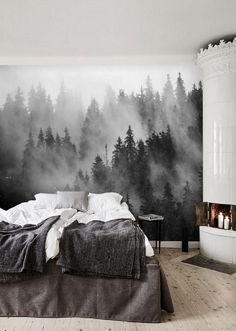 a bedroom with a large wall mural in the middle and a bed on the other side