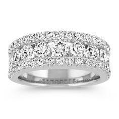 This classic wedding band features 47 pavé and channel-set round diamonds at approximately 2.20 carats total weight. Each magnificent gemstone has been hand-matched for exceptional beauty and sparkle. The quality 14 karat white gold setting measures an elegant 7.5mm at the center. Luxury Diamond Ring With Birthstone And Round Band, Luxury Diamond Ring With Diamond Accents And Round Band, Luxury Platinum Stackable Rings With Round Band, Luxury Platinum Diamond White Stackable Rings, Luxury Classic Bands With Single Cut Diamonds, Classic Luxury Bands With Single-cut Diamonds, Luxury Elegant Bands With Pave Setting, Luxury Diamond Cut Bands For Marriage, Luxury Wedding Bands With Single Cut Diamonds