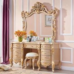 an ornate gold dressing table with stool and mirror