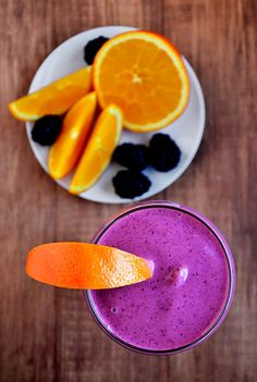 an orange and blueberry smoothie on a white plate