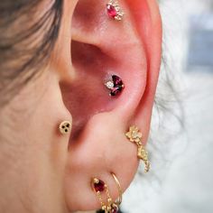 an ear with three different colored stones on it