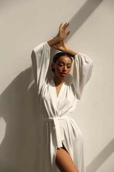 Our long bridal silk robe with wide long sleeves. It could be made of satin or pure mulberry silk. The robe is both casual and elegant, you may wear it on the hen party or spontaneously around your home on a daily basis. It is also an amazing outfit for your vocation, to wear it on the beautiful beach or by the pool as a cover up.-Our model wears size XS, her measurements are 82/61/87 cm and she is 172 cm tall.-Attached with belt.-Arrives beautifully packaged in tissue paper with ribbon -Length Satin V-neck Robe For Daywear, Satin Finish Kimono For Wedding Night With Kimono Sleeves, Satin Finish Kimono With Kimono Sleeves For Wedding Night, Elegant V-neck Kimono For Daywear, Satin Kimono With Kimono Sleeves For Wedding Night, White V-neck Robe For Sleep, Elegant Summer Wrap Sleepwear, Elegant Summer Sleep Kimono, Elegant Open Front Summer Robe